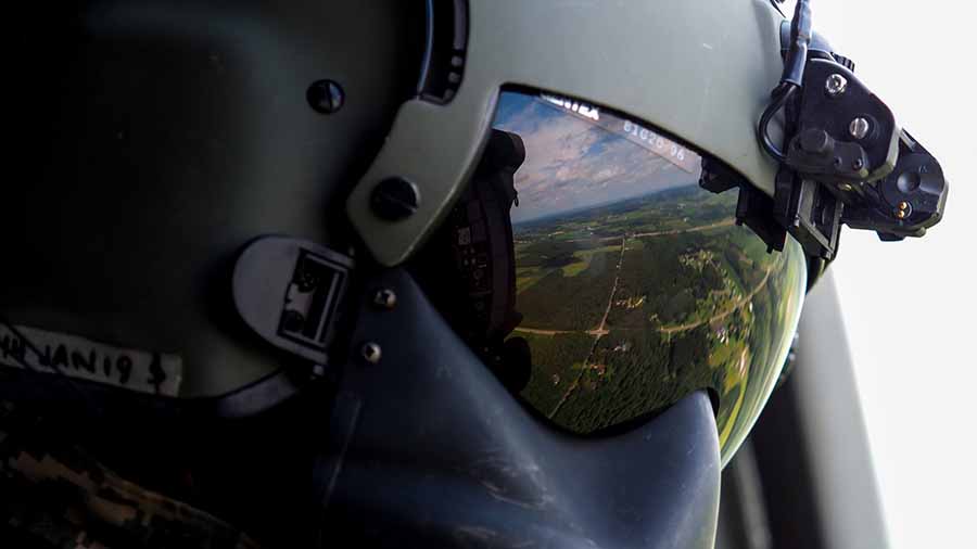 Pilot Visor Reflecting land below during flight